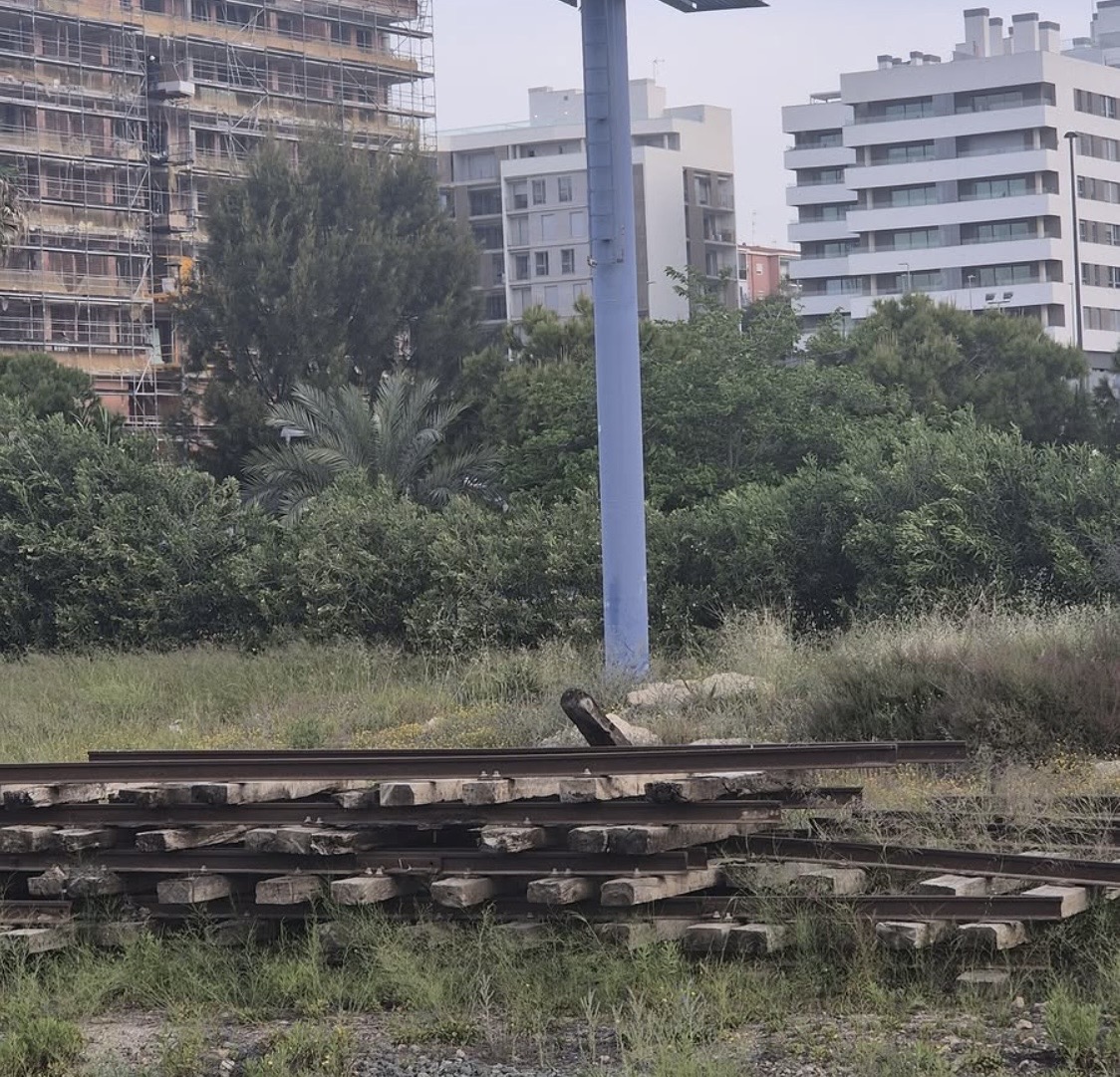 Vías y traviesas acumuladas en el entorno abandonado del acceso sur