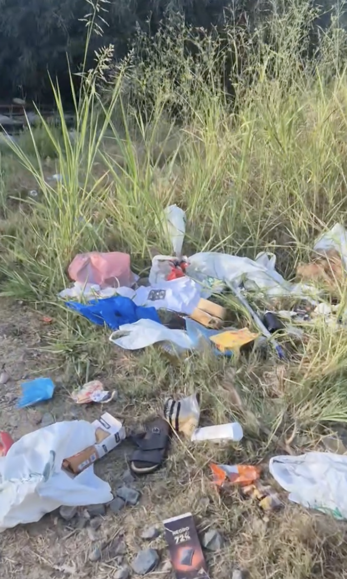 Bolsas y residuos esparcidos entre la hierba alta en los antiguos terrenos ferroviarios de ADIF